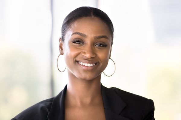 Sarah M., CEO and Founder, smiling in a black blazer
